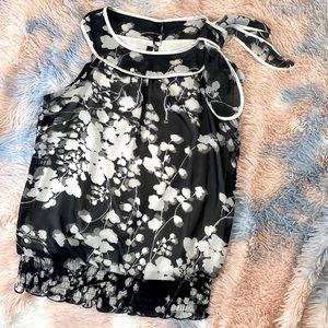 Floral black and white sleeveless blouse.